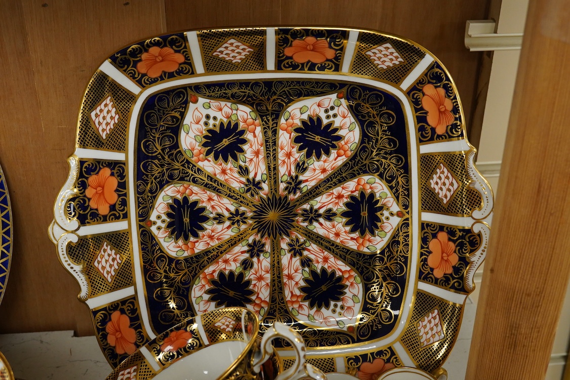 A quantity of Royal Crown Derby Imari to include a sandwich plate, cups and saucers and and miniature twin handled cups, largest 27cm in diameter